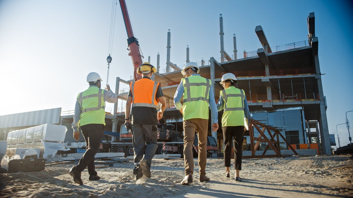 Team of commercial development finance specialists walking on site